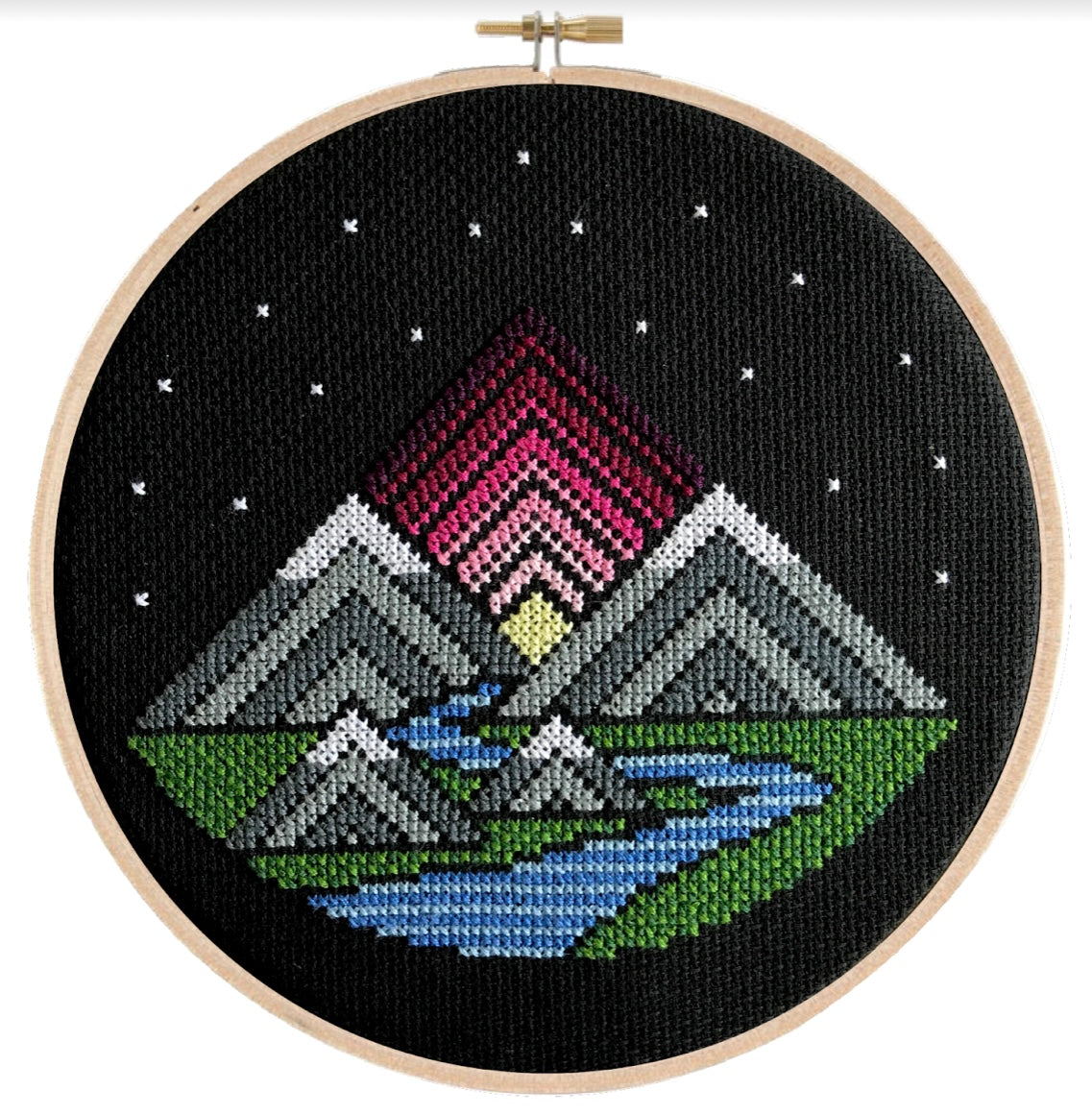 cross stitch on black canvas mountains and river