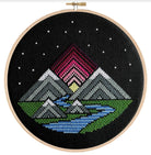 cross stitch on black canvas mountains and river