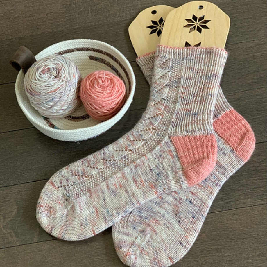 hand knit socks displayed  with bowl of yarn