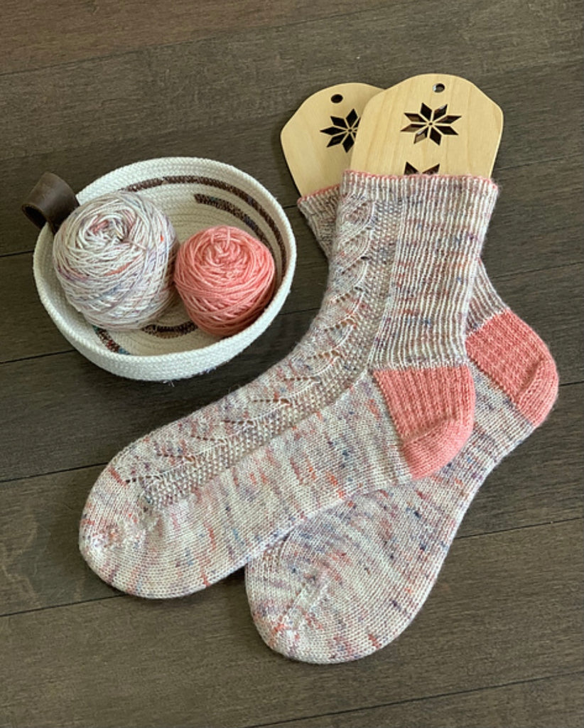 hand knit socks displayed  with bowl of yarn