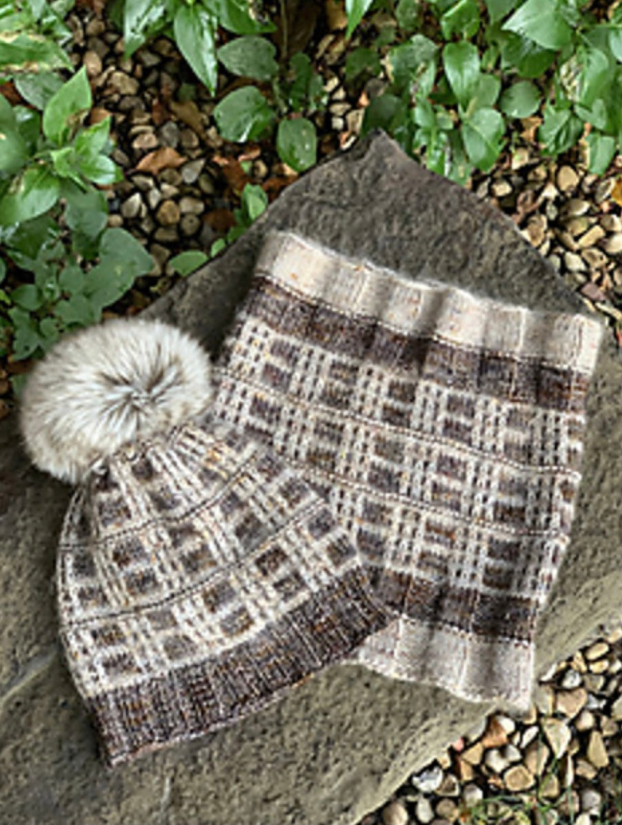 hand knit hat and cowl displayed in garden setting