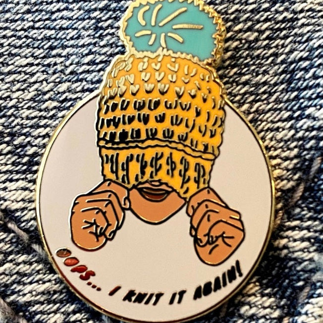 enamel pin of woman wearing knit hat