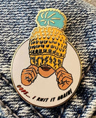 enamel pin of woman wearing knit hat